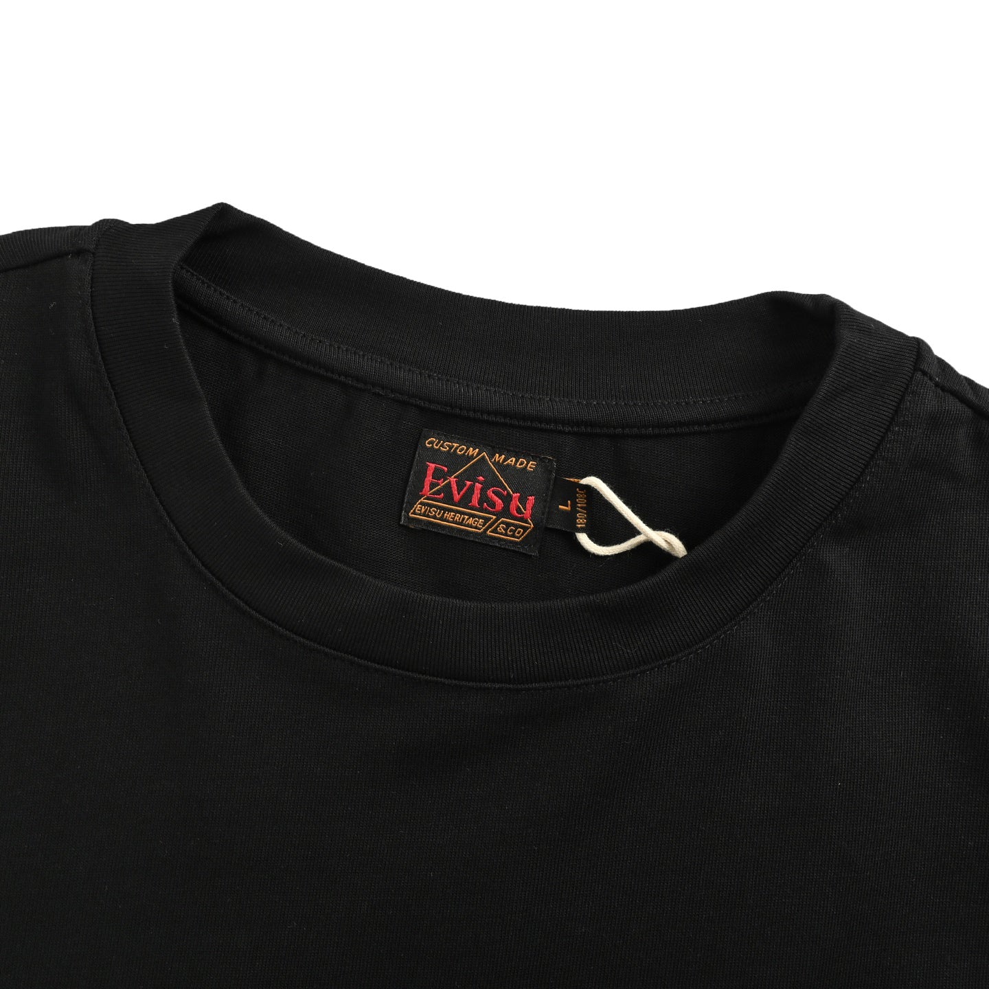 The T-shirt is from EVISU's "Heart-Hand Buddha Head" series.