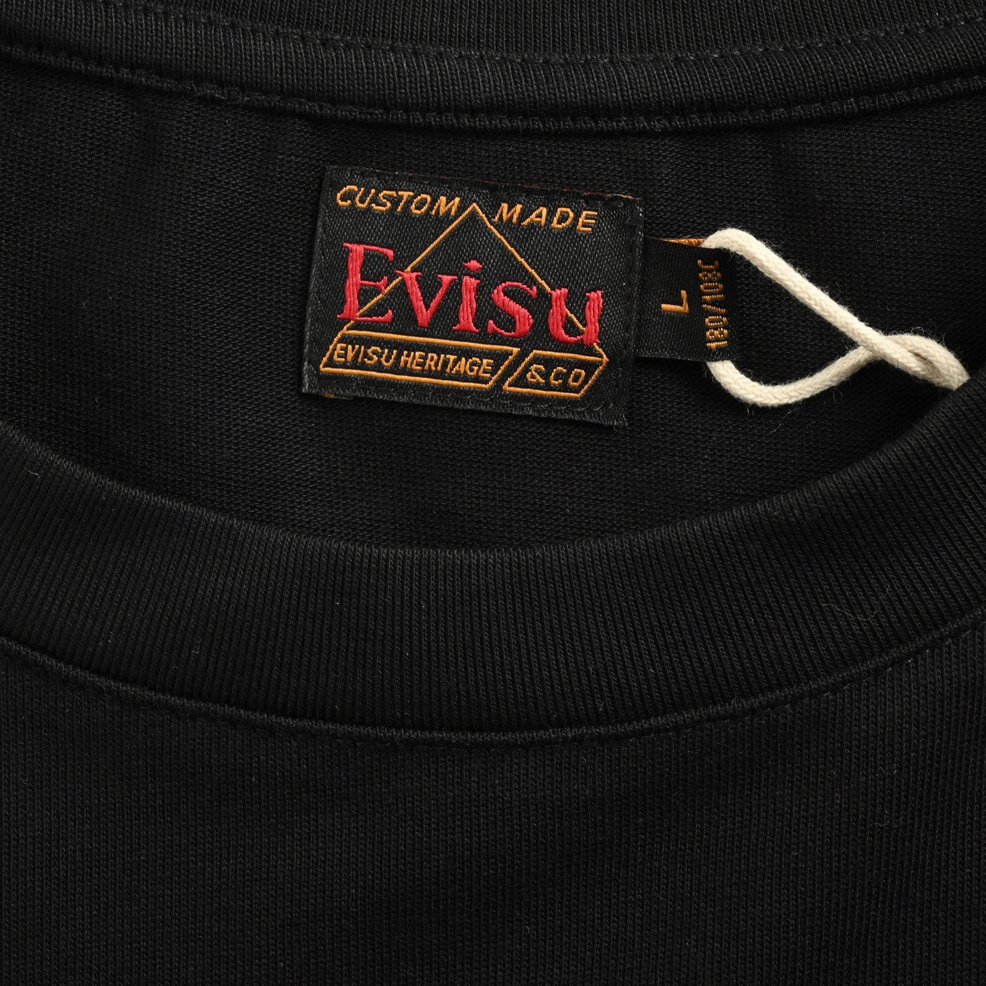 The T-shirt is from EVISU's "Heart-Hand Buddha Head" series.