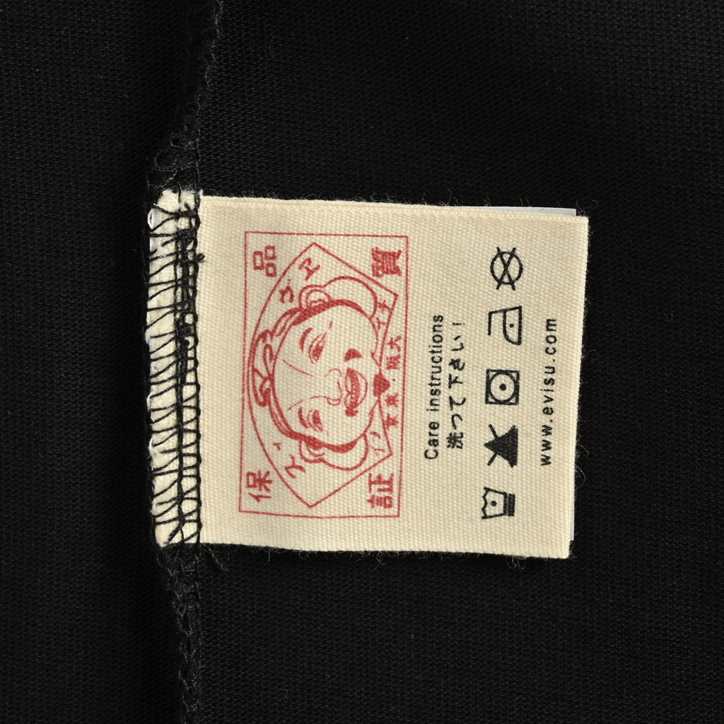 The T-shirt is from EVISU's "Heart-Hand Buddha Head" series.