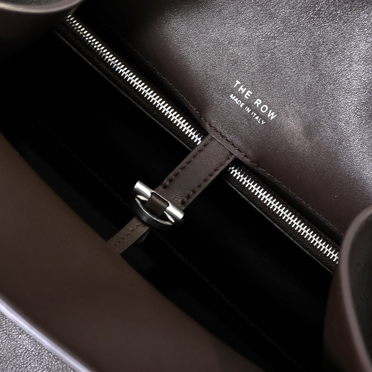 The Row Margaux 15 Smooth Calfskin Handbag | Large Leather Tote with Side Buckles | Black / Dark Chocolate