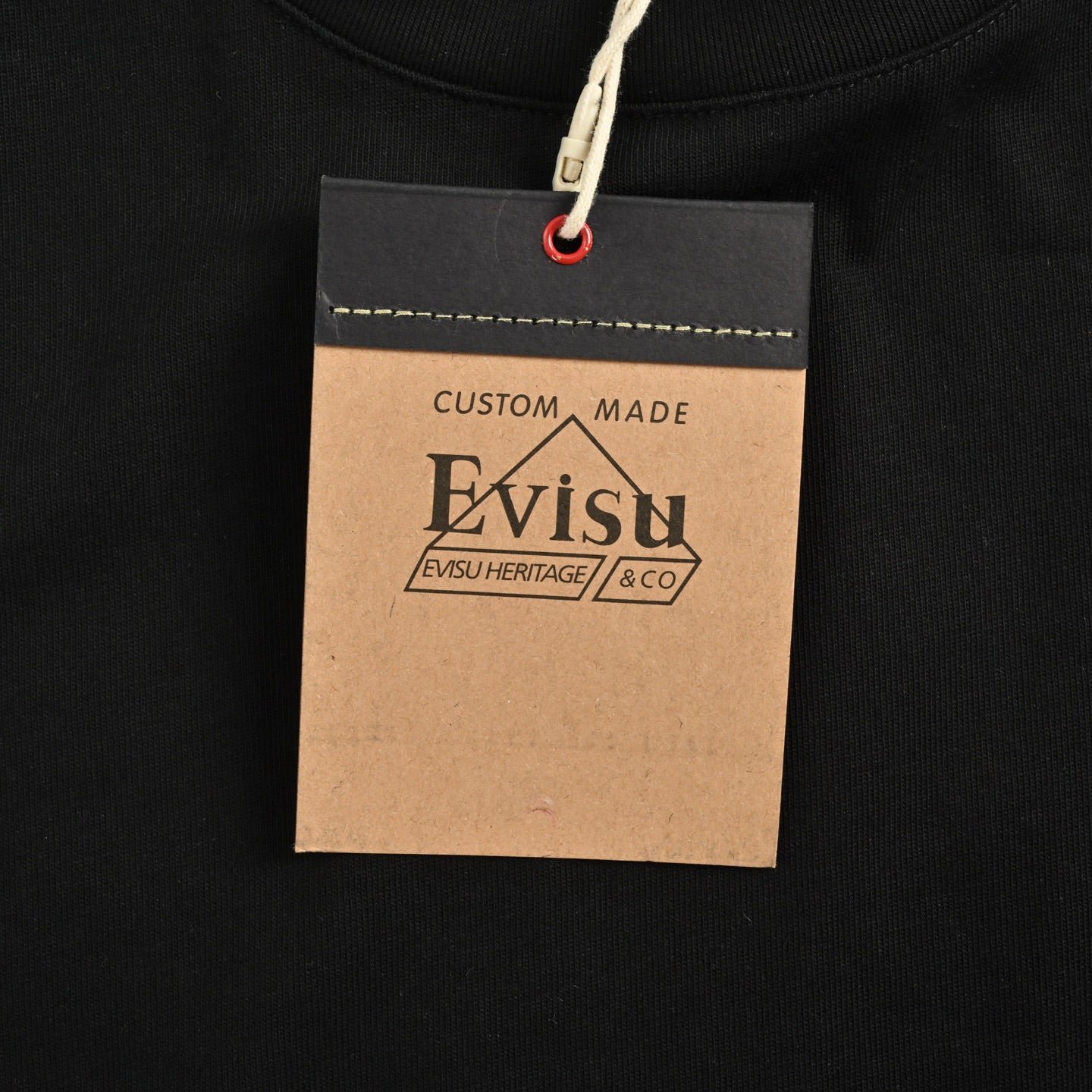 The T-shirt is from EVISU's "Heart-Hand Buddha Head" series.