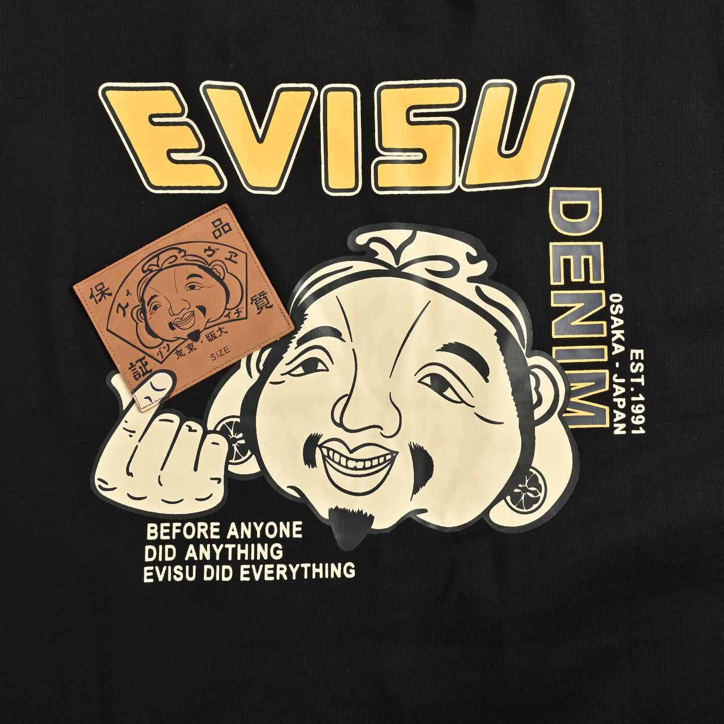 The T-shirt is from EVISU's "Heart-Hand Buddha Head" series.