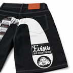 EVISU Denim Shorts featuring a Distressed, Paneled "Big M" Print