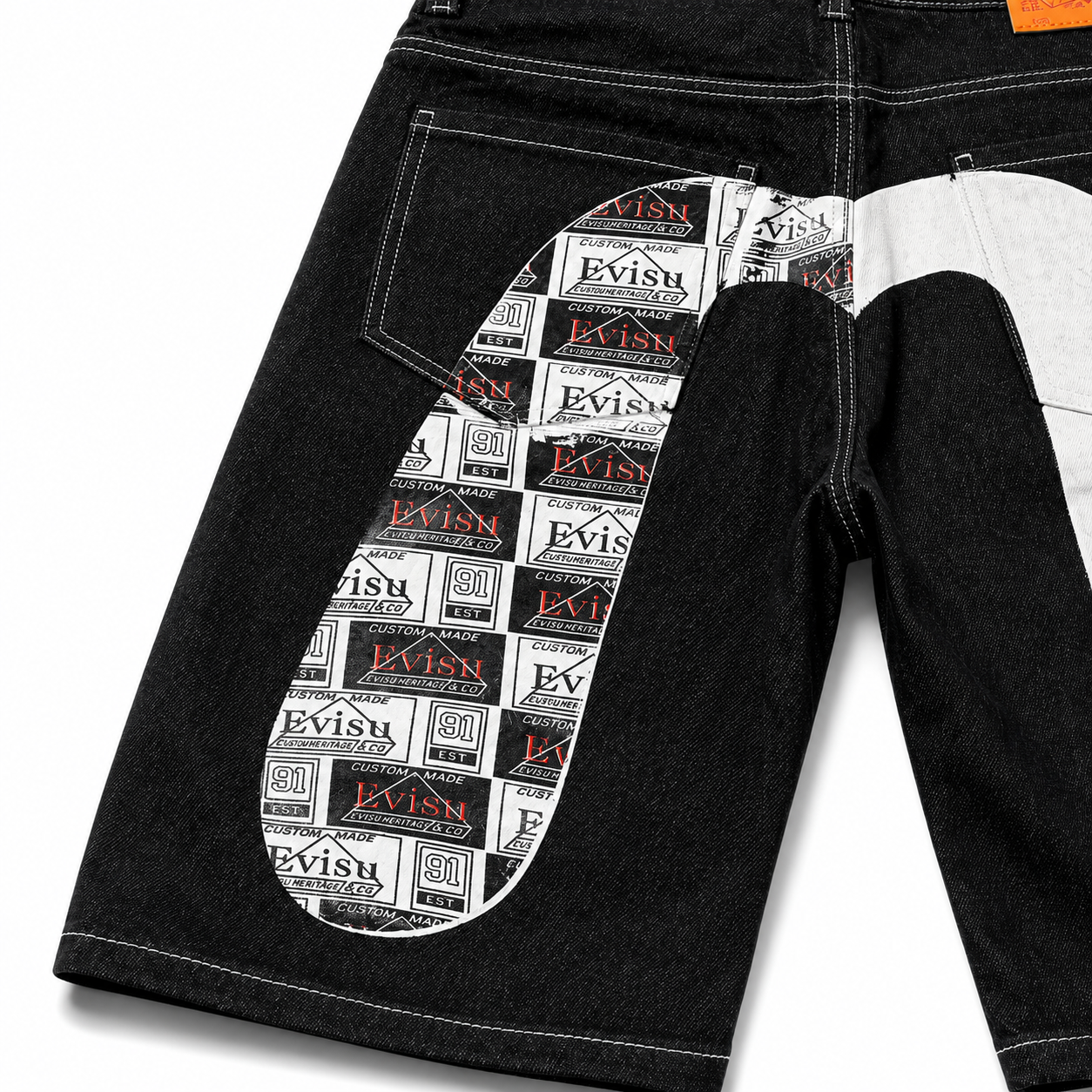 EVISU Denim Shorts featuring a Distressed, Paneled "Big M" Print