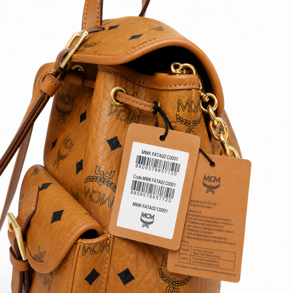 MCM Aren Mini Drawstring Chain Backpack in Cognac Visetos – Signature Monogram with Gold Chain Detail