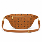 MCM Visetos Belt Bag with Bow in Cognac – Monogram Coated Canvas Waist Bag with Leather Bow, Rivets & Detachable Leather Strap, 25x18cm