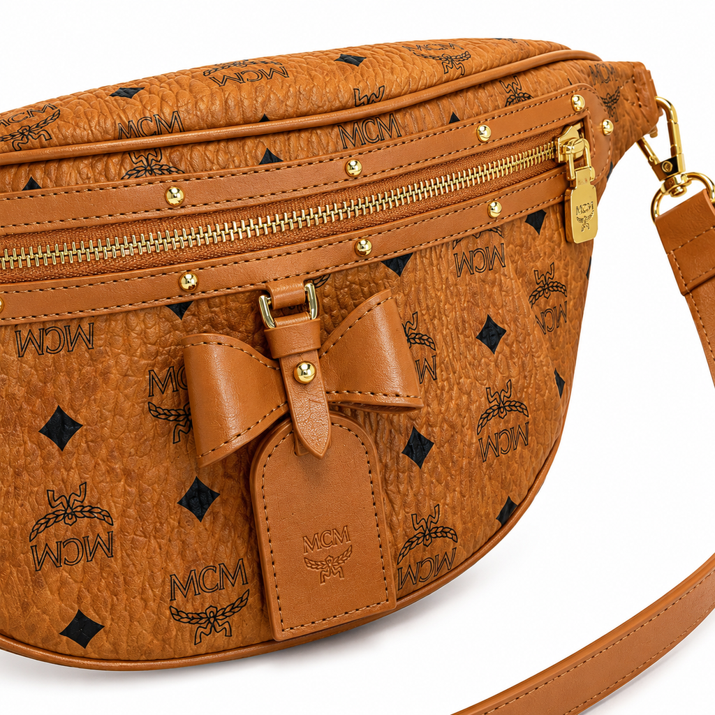 MCM Visetos Belt Bag with Bow in Cognac – Monogram Coated Canvas Waist Bag with Leather Bow, Rivets & Detachable Leather Strap, 25x18cm